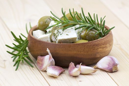 feta cheese and olives with herbs in olive oil