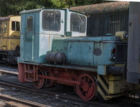 old rusted blue locomotive train at trainstation hombourg in belgium