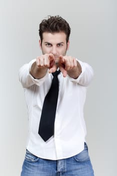 man in white shirt and tie pointing with both hands toward camera - isolated on gray