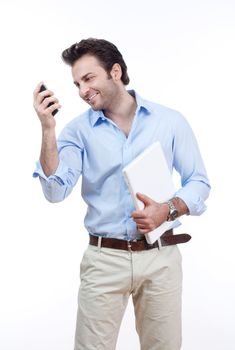 businessman with laptop looking at cellphone, smiling- isolated on white