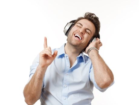 man in blue shirt with earphones listening to music - isolated on white