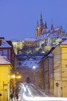 prague in winter - hradcany castle and traffic at mala strana at dusk