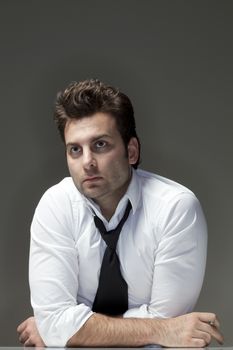 man in white shirt looking up, thinking - isolated on gray