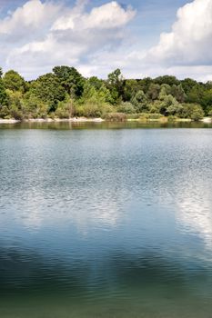 Image of a beautiful lake with trees and blue sky in Germany Bavaria in summer