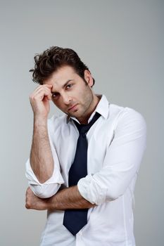 businessman in white shirt and tie, concerned, worried - isolated on gray