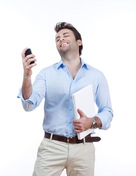 businessman with laptop looking at cellphone, smiling- isolated on white