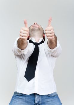 excited man laughing holding his both thumbs up - isolated on white