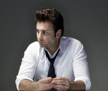 businessman in white shirt and tie, concerned, worried - isolated on gray