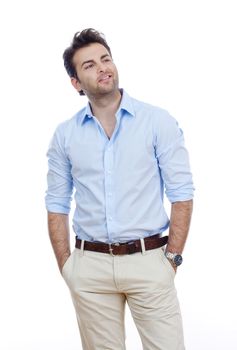 man in blue shirt and light trousers standing, smiling- isolated on white