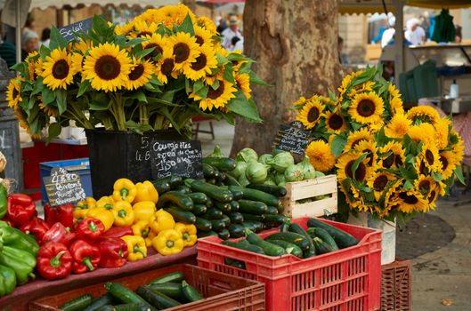 Fresh vegetables and sunflower blossoms for sale at farmers market in Aiv en Provence, France