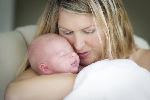 Young Caucasian Beautiful Mother Holding Her Precious Newborn Baby Girl.