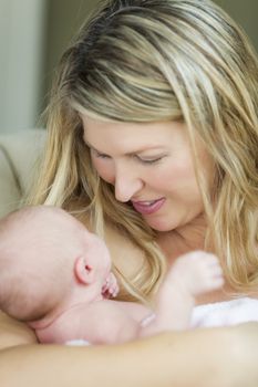 Young Caucasian Beautiful Mother Holding Her Precious Newborn Baby Girl.