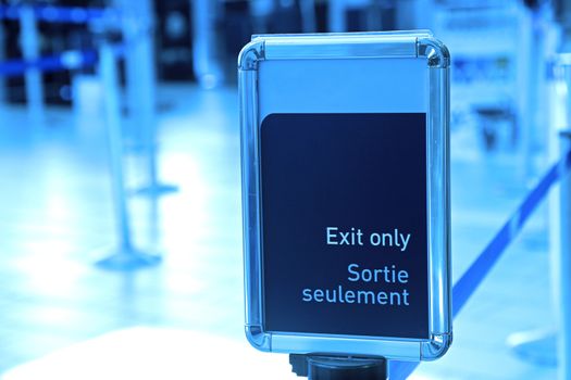 Exit sign in an airport with blue toned