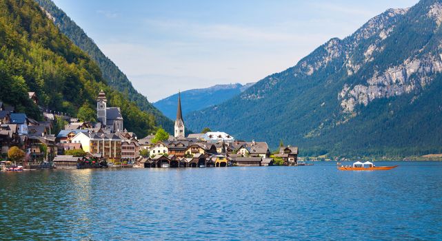 Panoramic view of Hallstatt village with traditional boat on lake, Hallstatt, Austria
