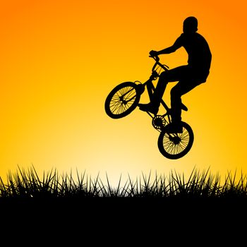 Silhouette of a biker jumping in the sunset