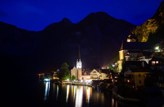 Night view of Hallstatt village with Christuskirche church bell tower, Austria
