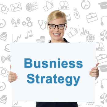 Smiling businesswoman holding business strategy banner