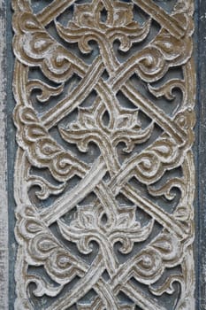 Old abstract design decorative bas relief on stone wall