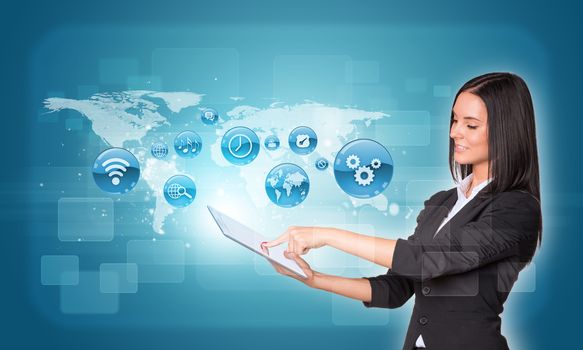 Beautiful businesswomen in suit using digital tablet. World map with app icons