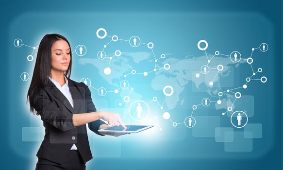 Beautiful businesswomen in suit using digital tablet. World map with network