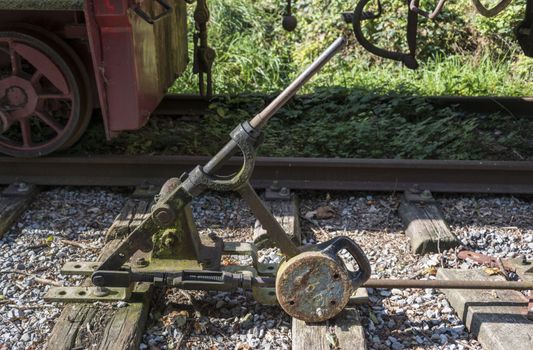 Old railroad track switch with train background