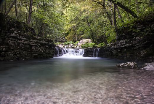 small waterfall on Tolminka alpine river in Slovenia, central europe