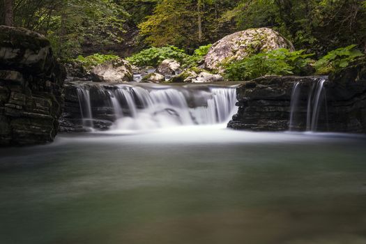 small waterfall on Tolminka alpine river in Slovenia, central europe