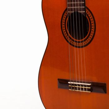 Old wooden brown guitar body over white background