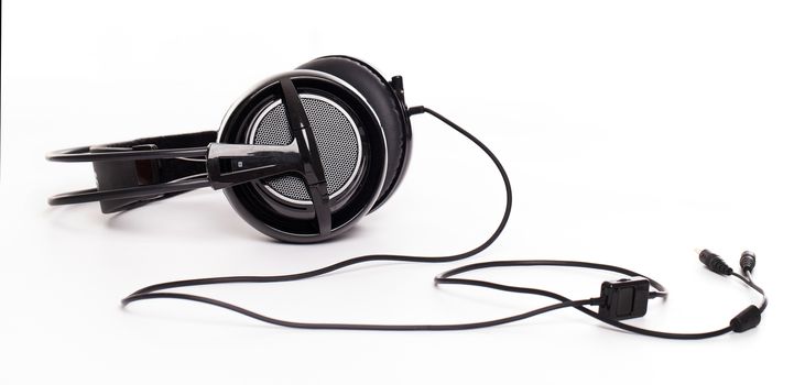 Closeup image of big black headphones on a white background
