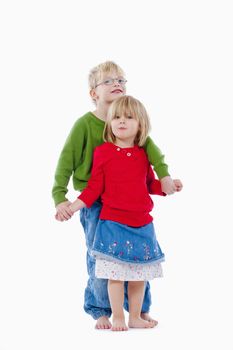 children - portrait of brother and sister standing, holding hands - isolated on white