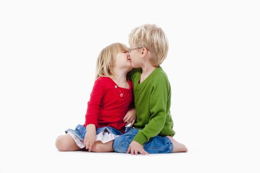 children - brother and sister kissing each other - isolated on white