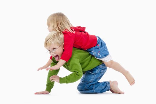 two young siblings fooling around with each other - isolated on white