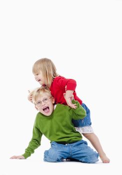 two young siblings fooling around with each other - isolated on white