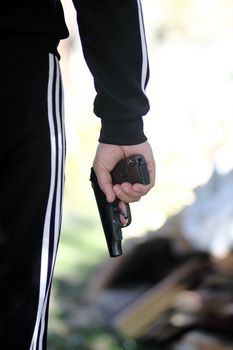 man in a tracksuit with a gun.