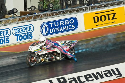 Northamptonshire, UK - October 29, 2011: Extreme sportsman Eric Teboul at the start of his world record breaking 280mph rocket drag-bike run at Santa Pod Raceway in Northamptonshire, UK