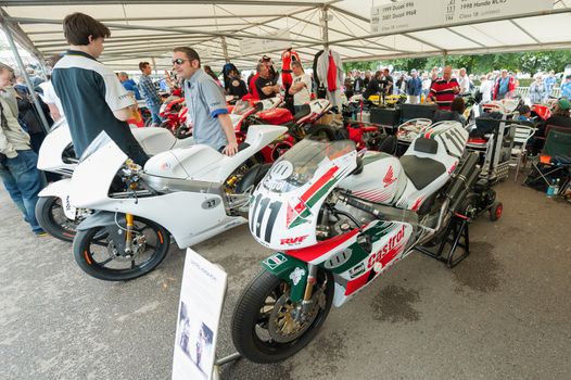 GOODWOOD, UK - JULY 1, 2012: Classic Honda and Ducati racing bikes in the service pits at the Festival of Speed motor-sport event held at Goodwood, UK on July 1, 2012