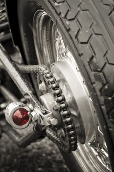 motorcycle rear wheel and drive chain closeup