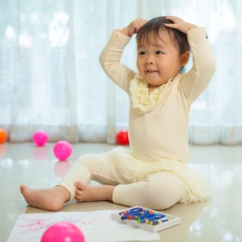 Portrait of little asian girl in home