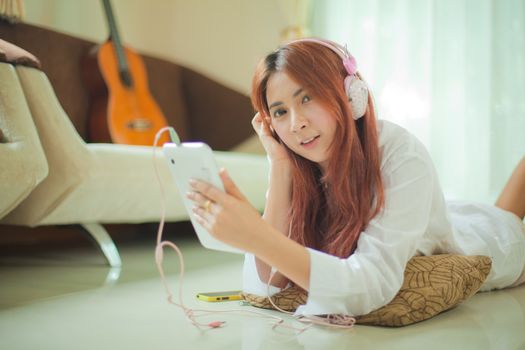 Young asian beautiful woman with smart phone and listening to music