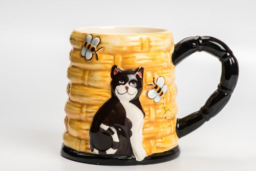 Yellow ceramic mug with cat  on white background