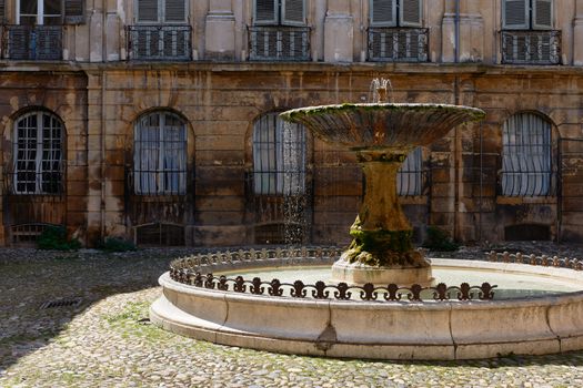 Ancient fountain in old part of Aix en Provence town, South France