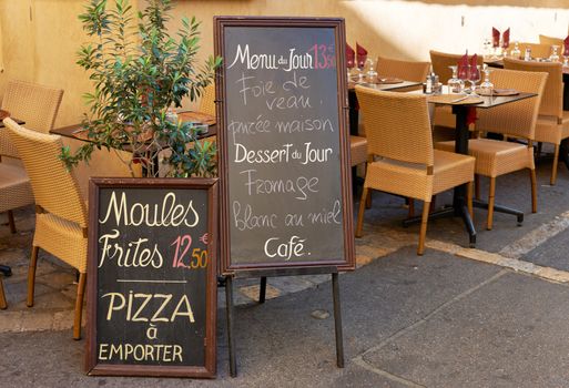 Menu and tables of street restaurant in Aix en Provence town, PACA, France