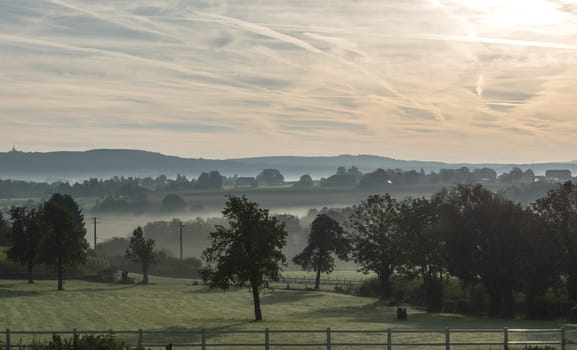 morning landscape with the hills in belgium with mist meadow 