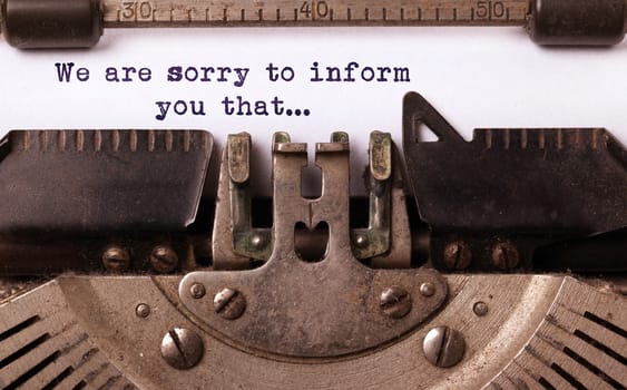 Vintage inscription made by old typewriter, we are sorry to inform you that