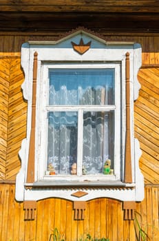 Carved window in old russian wooden country house