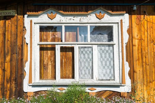 Carved window in old russian wooden country house