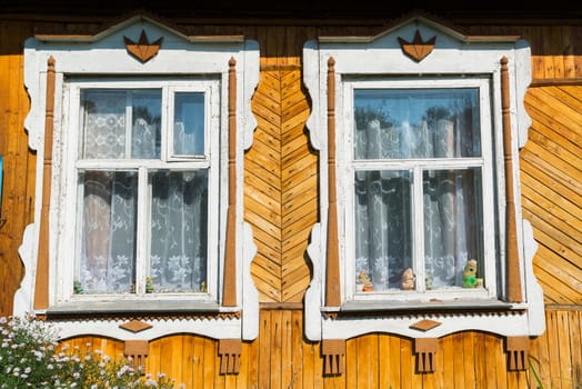 Carved window in old russian wooden country house