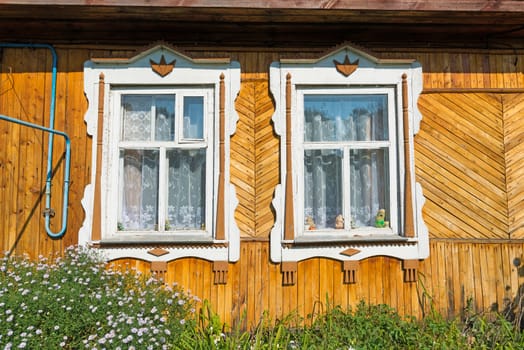 Carved window in old russian wooden country house