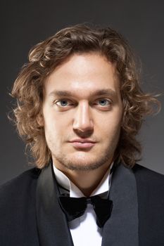 Portrait of a Young Man with Brown Hair in Tuxedo