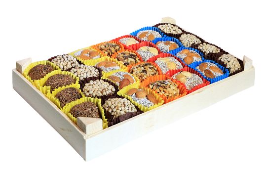 Turkish sweets, candies in a wooden box on the white background, isolated
